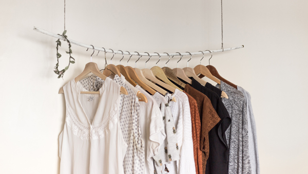 neutral clothes hanging on a rail