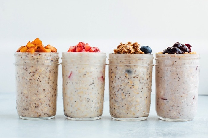 four cups of overnight oats with various fruits